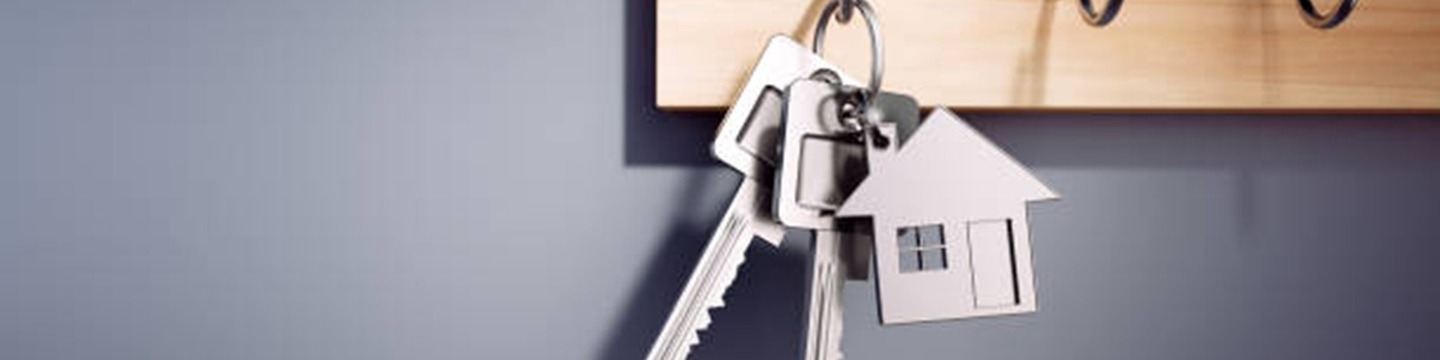A set of house keys, hanging on a hook