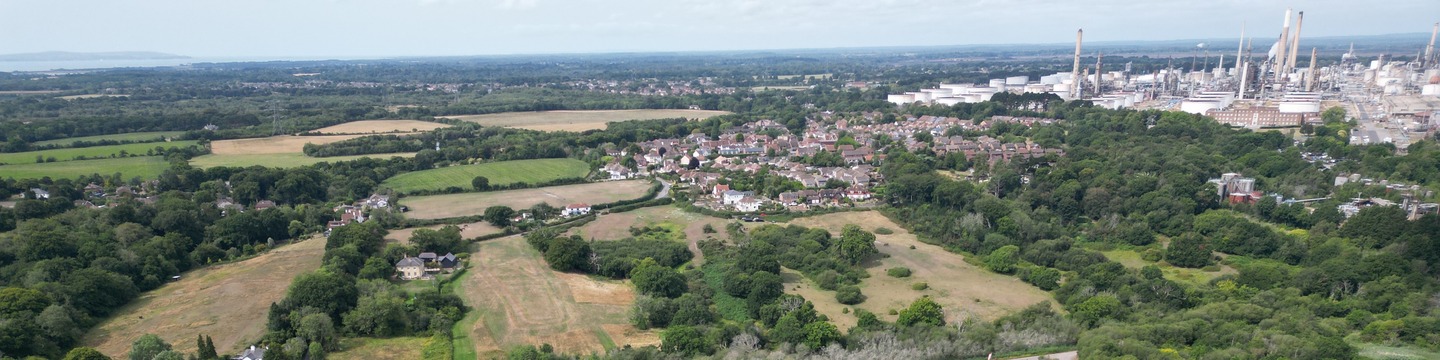 An aerial image of a settlement, countryside and power station