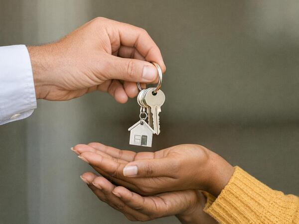 Image of keys being passed between hands